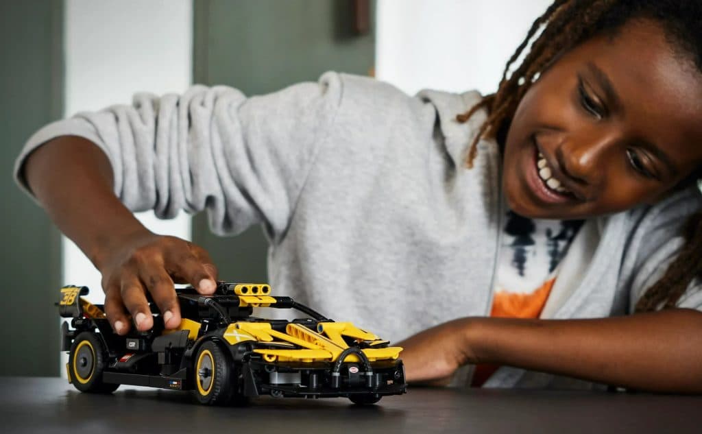 A child playing with their LEGO Technic Bugatti Bolide