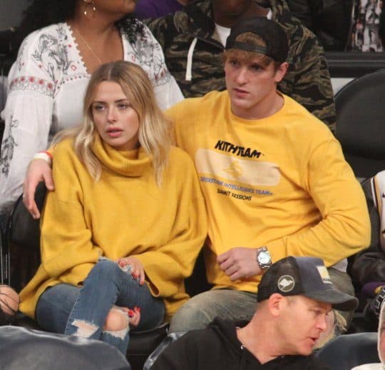 Logan Paul sits with Corinna Kopf at a Lakers basketball game.