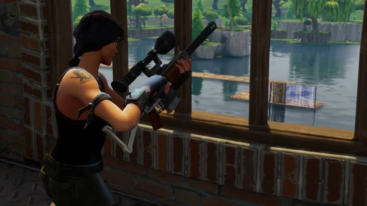 Fortnite sniper patiently waiting indoors.