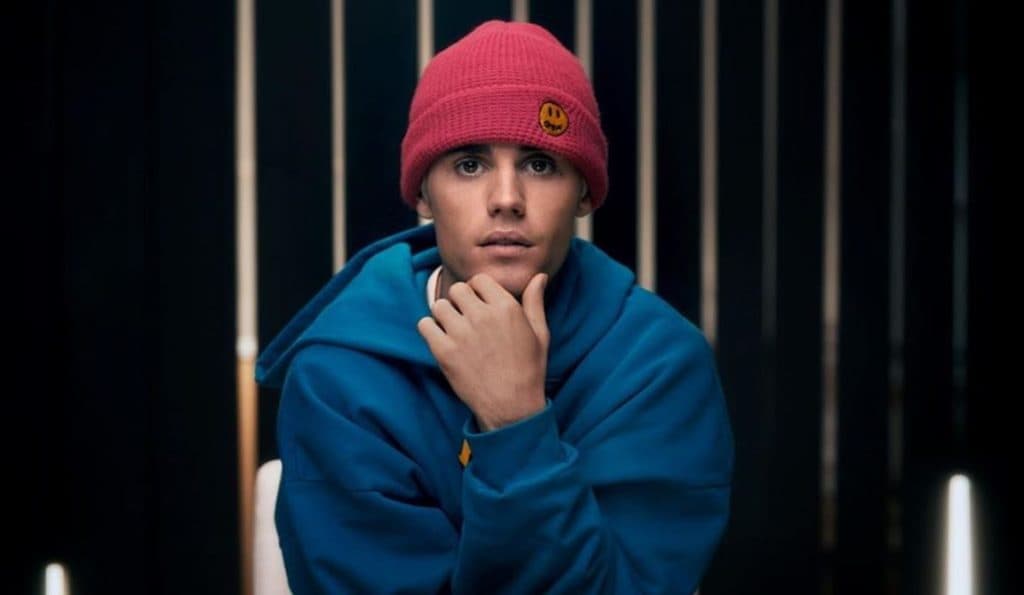 Justin Bieber poses in a pink beanie.