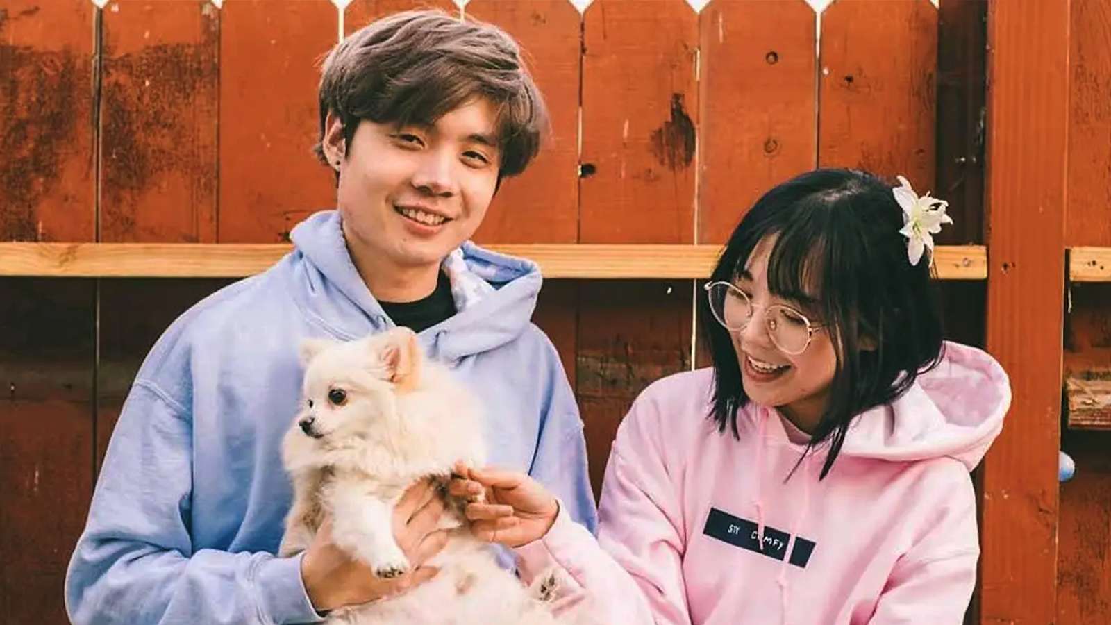 Sleightlymusical and LilyPichu holding dog together