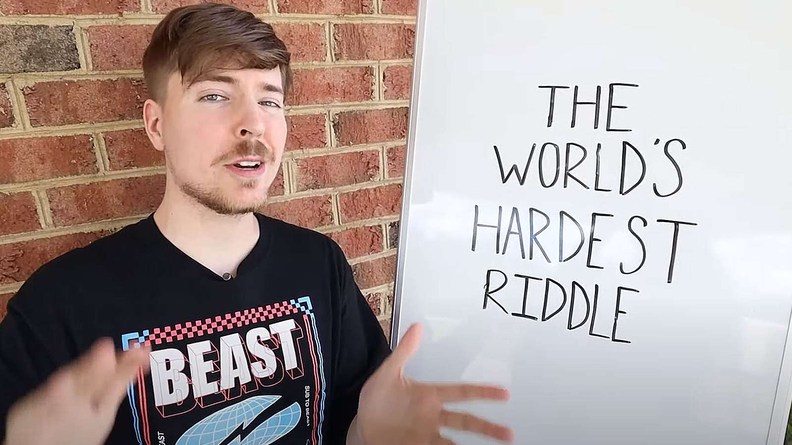 Mr Beast stands next to a white board that reads, "World's hardest riddle."