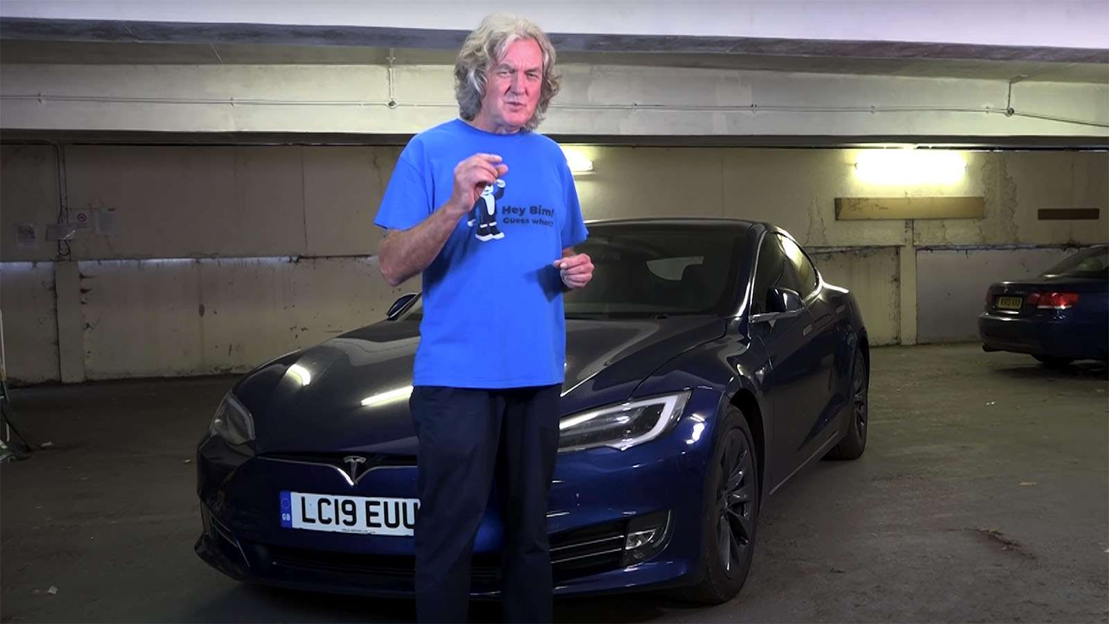 James may standing in front of tesla