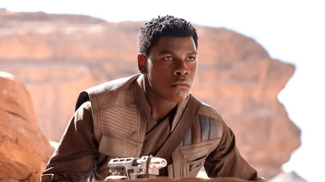 Finn holding a blaster in star wars