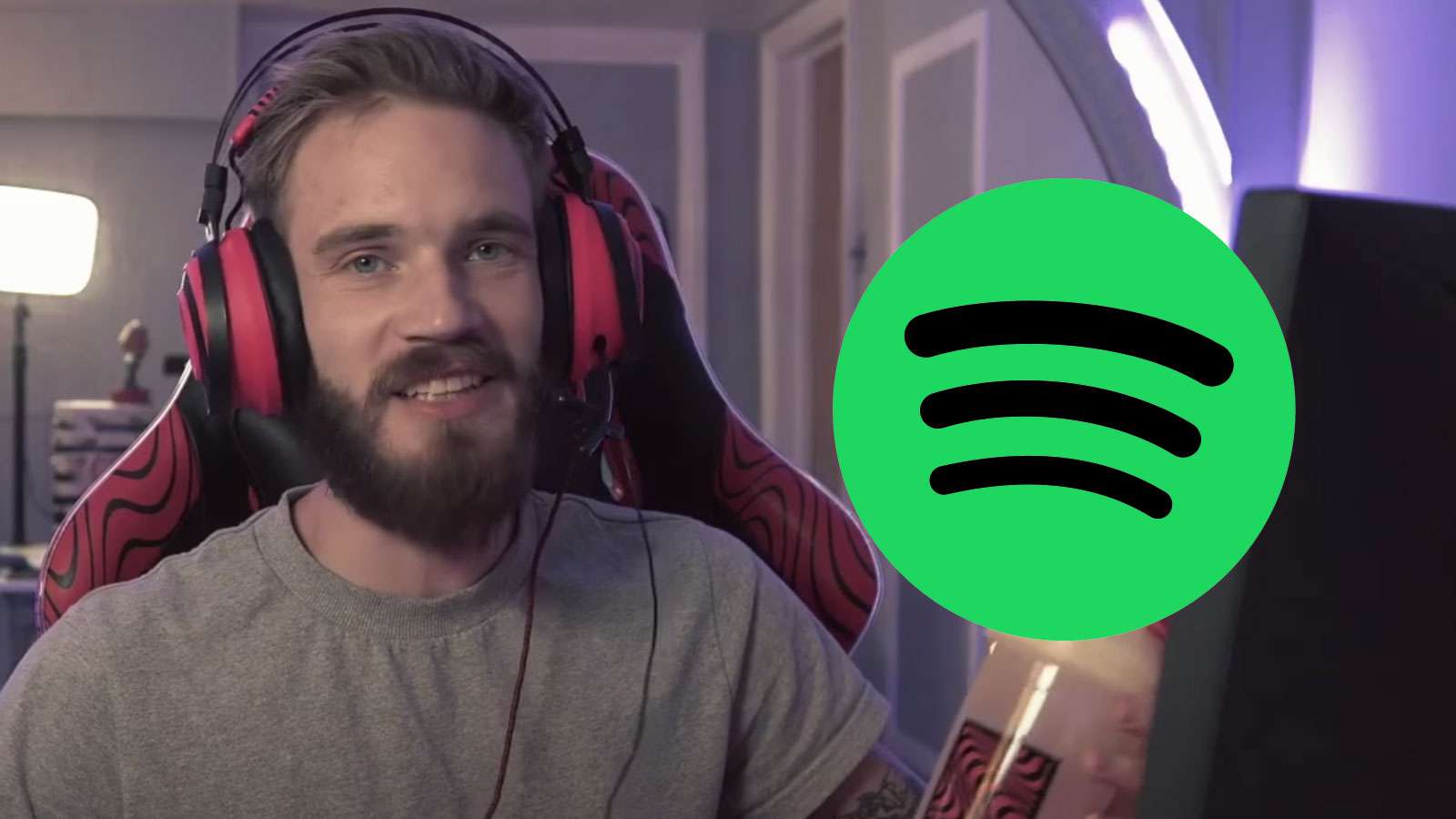 PewDiePie talks to the camera beside the Spotify logo.