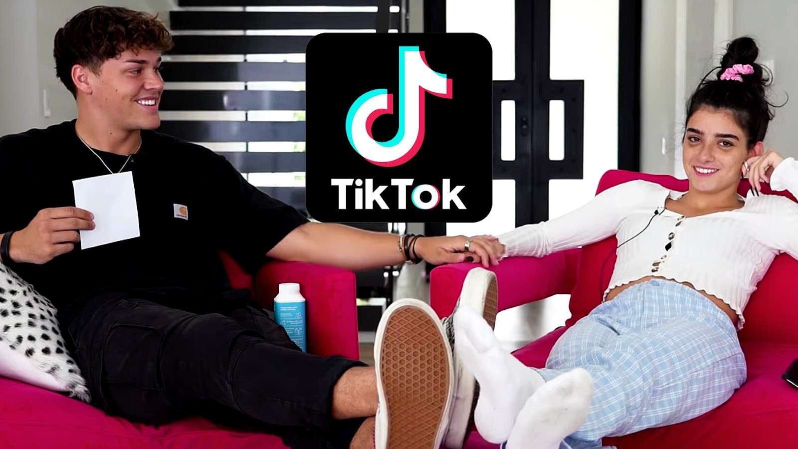 Dixie and Noah holding hands by TikTok logo