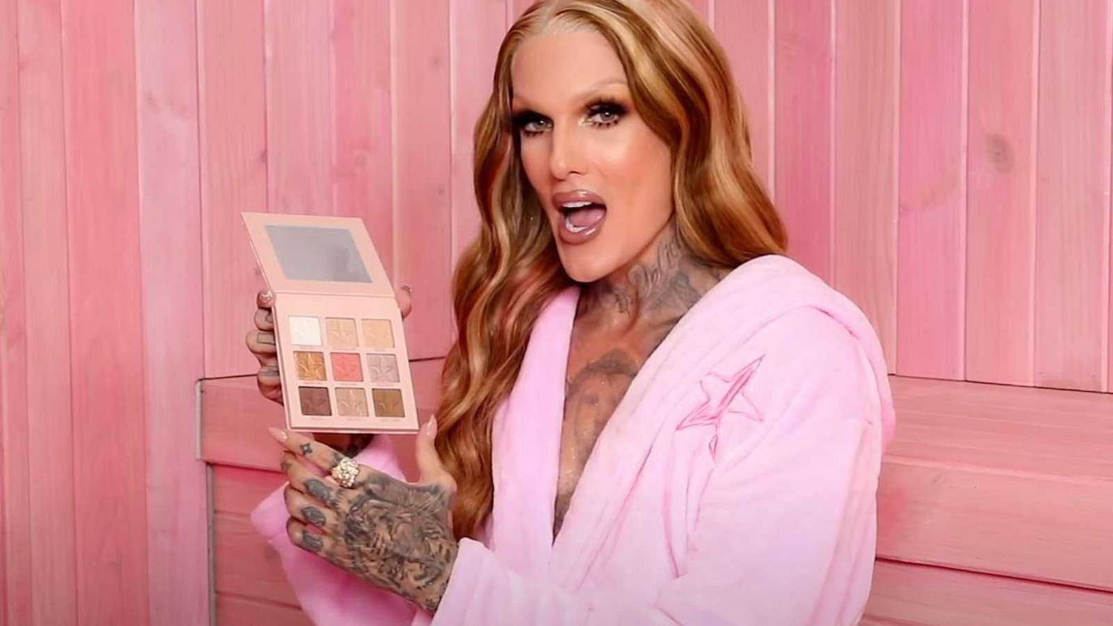 Jeffree Star holds up the miniature version of his latest palette.
