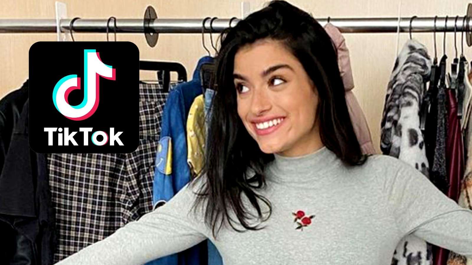 Dixie D'Amelio stands in front of clothes next to the TikTok logo
