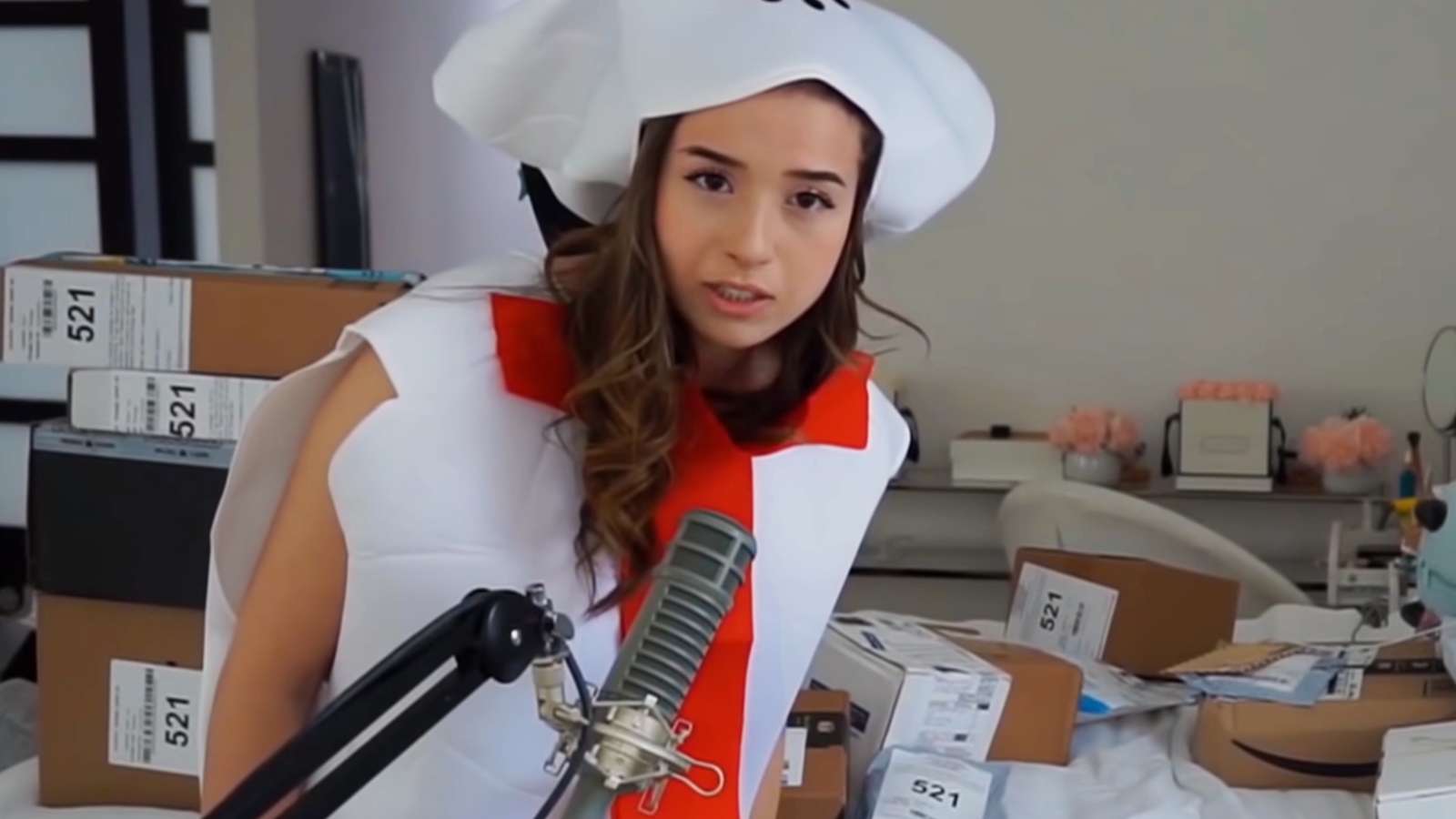 Pokimane unwraps presents in a Christmas costume on Twitch.