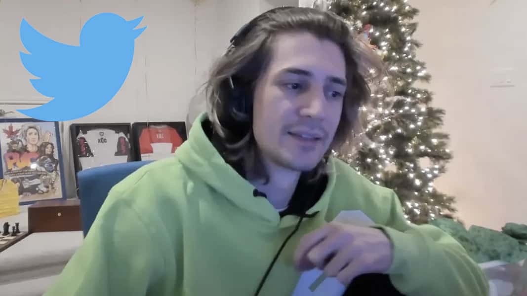 Screenshot of xQc sat by a christmas tree in a green hoodie with the Twitter logo