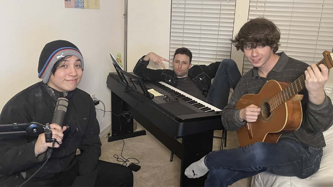 AustinShow, Quackity, and Karl Jacobs posing with instruments