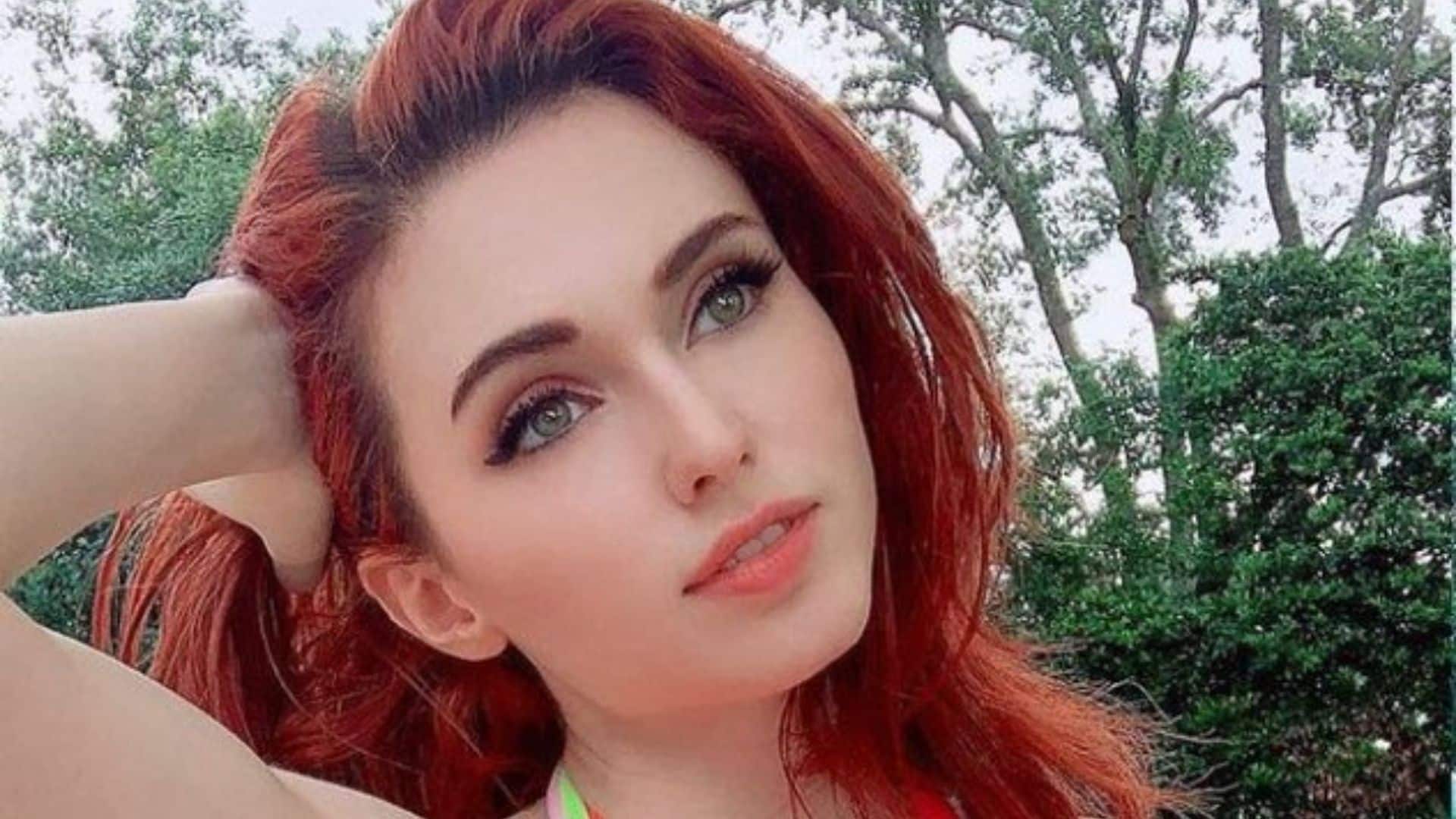 Amouranth posing by a pool on Twitch