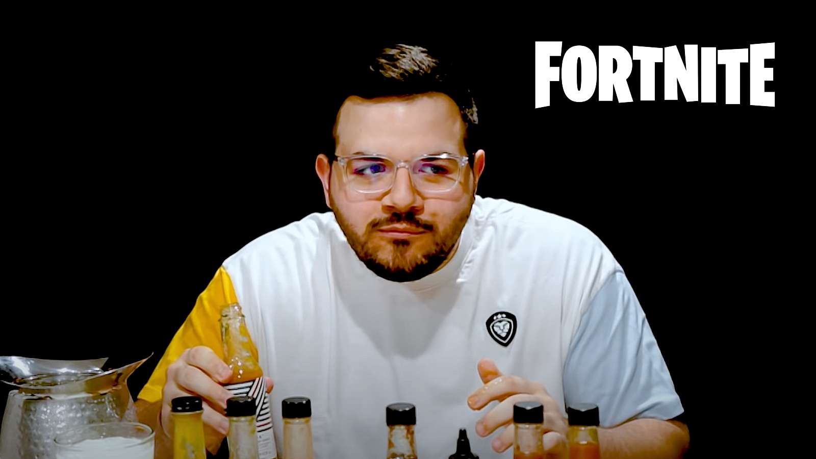 CouRageJD eating hot wings with Fortnite logo