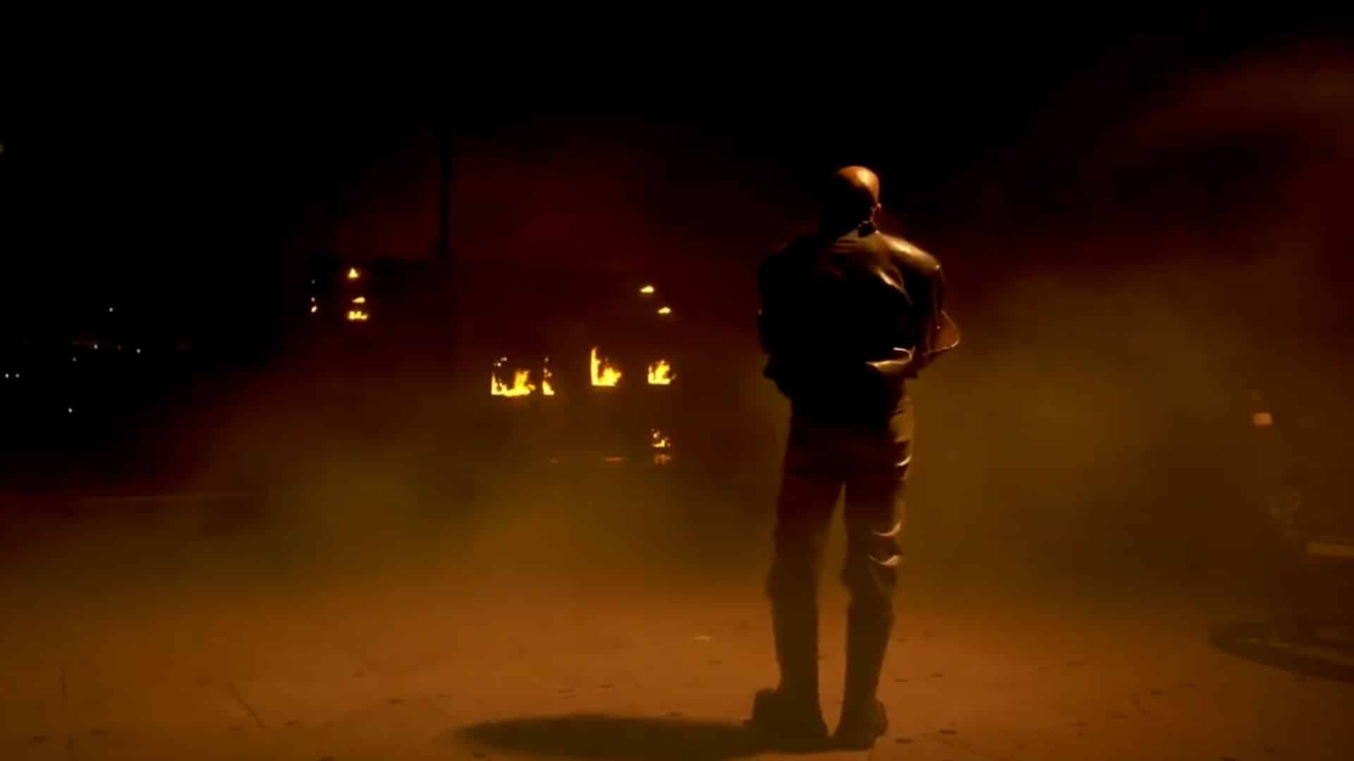 Kanye West in front of a burning house as part of Donda 2 Livestream