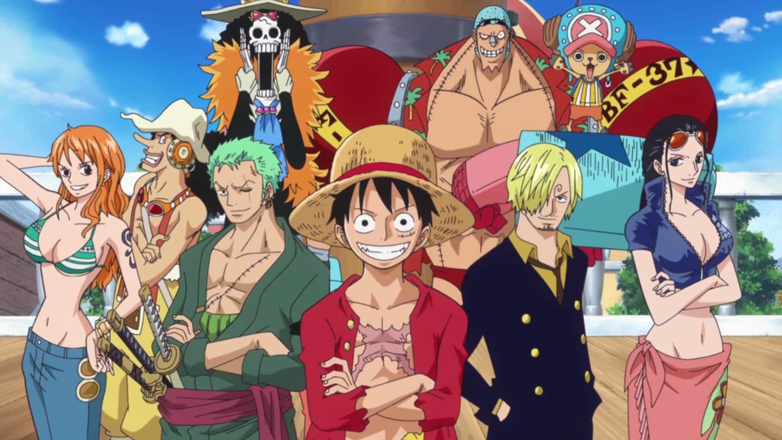 The cast and characters of the One Piece anime standing together and smiling