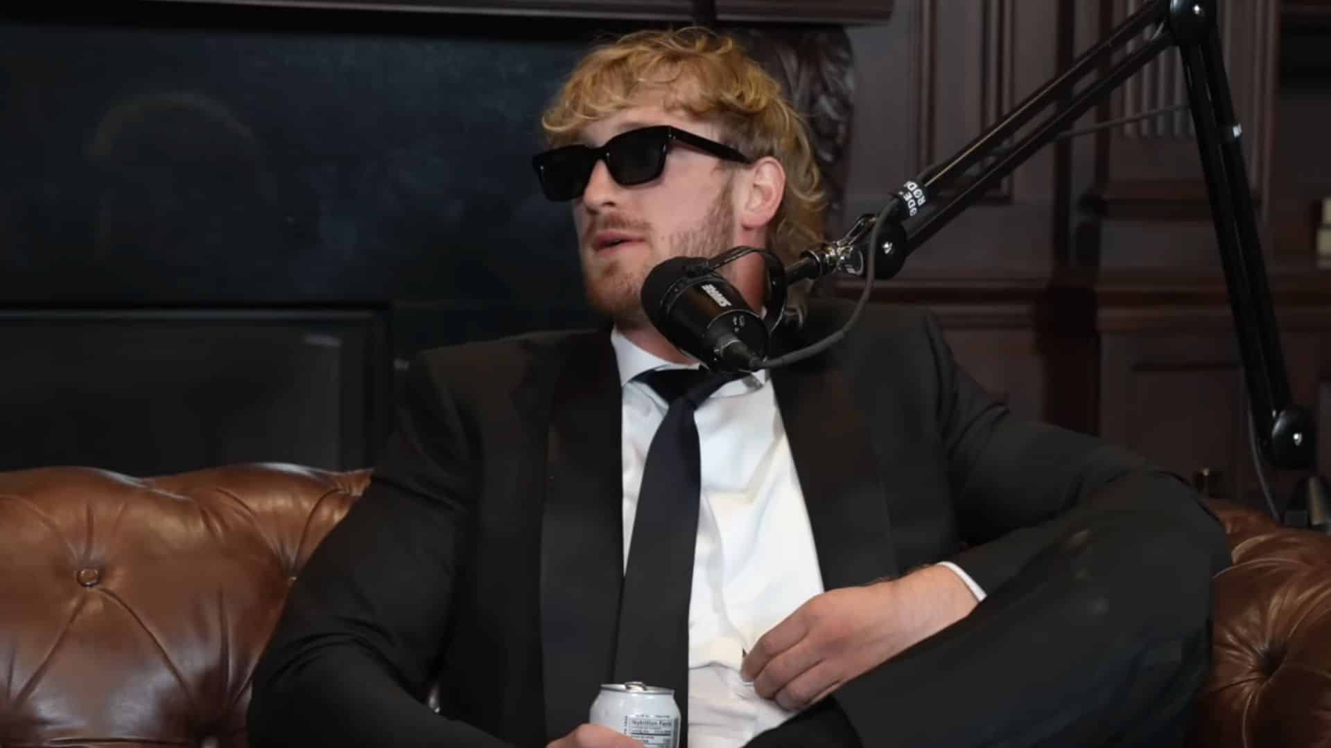 Logan Paul talking into mic wearing suit and sunglasses