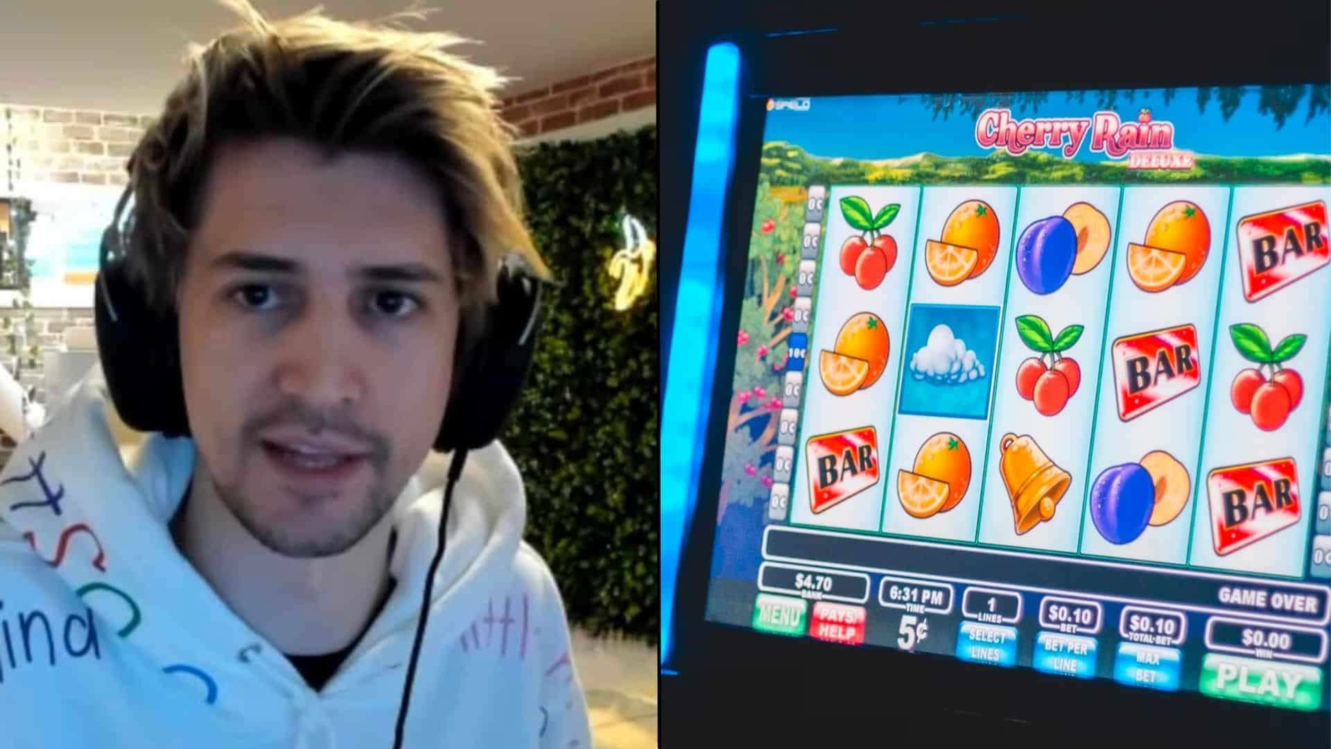 xQc sitting next to colorful slot machine with fruit symbols