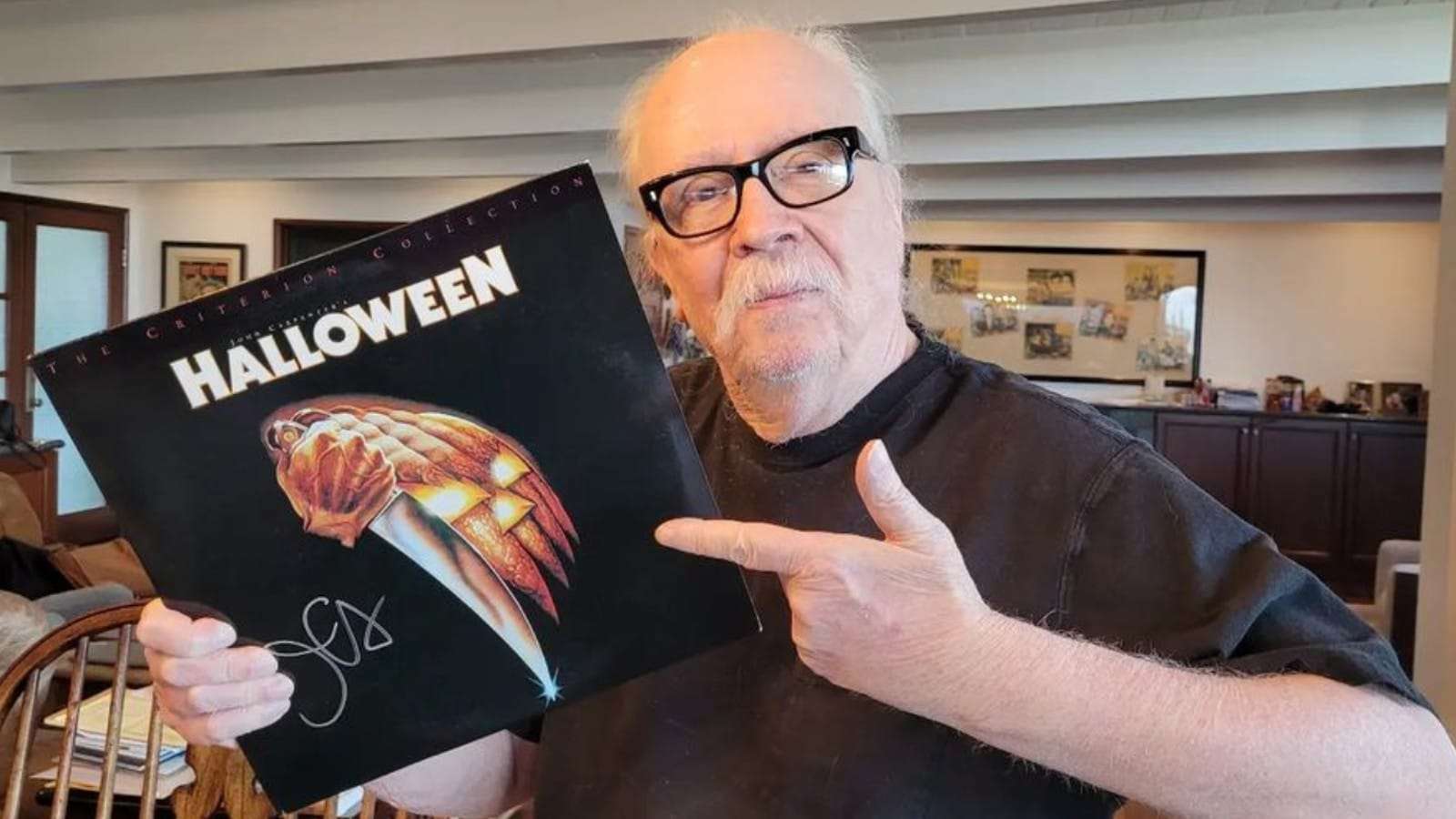 John Carpenter holding a Halloween vinyl