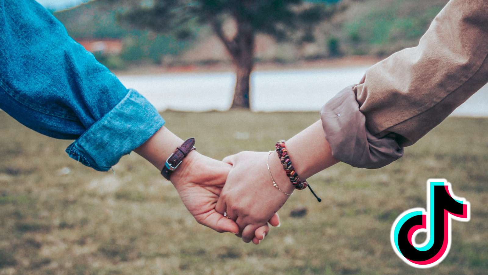 Two people holding hands next to TikTok logo