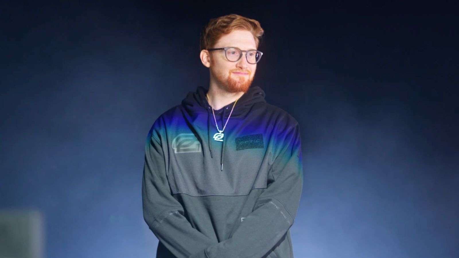 OpTic Scump standing in front of smoky background.