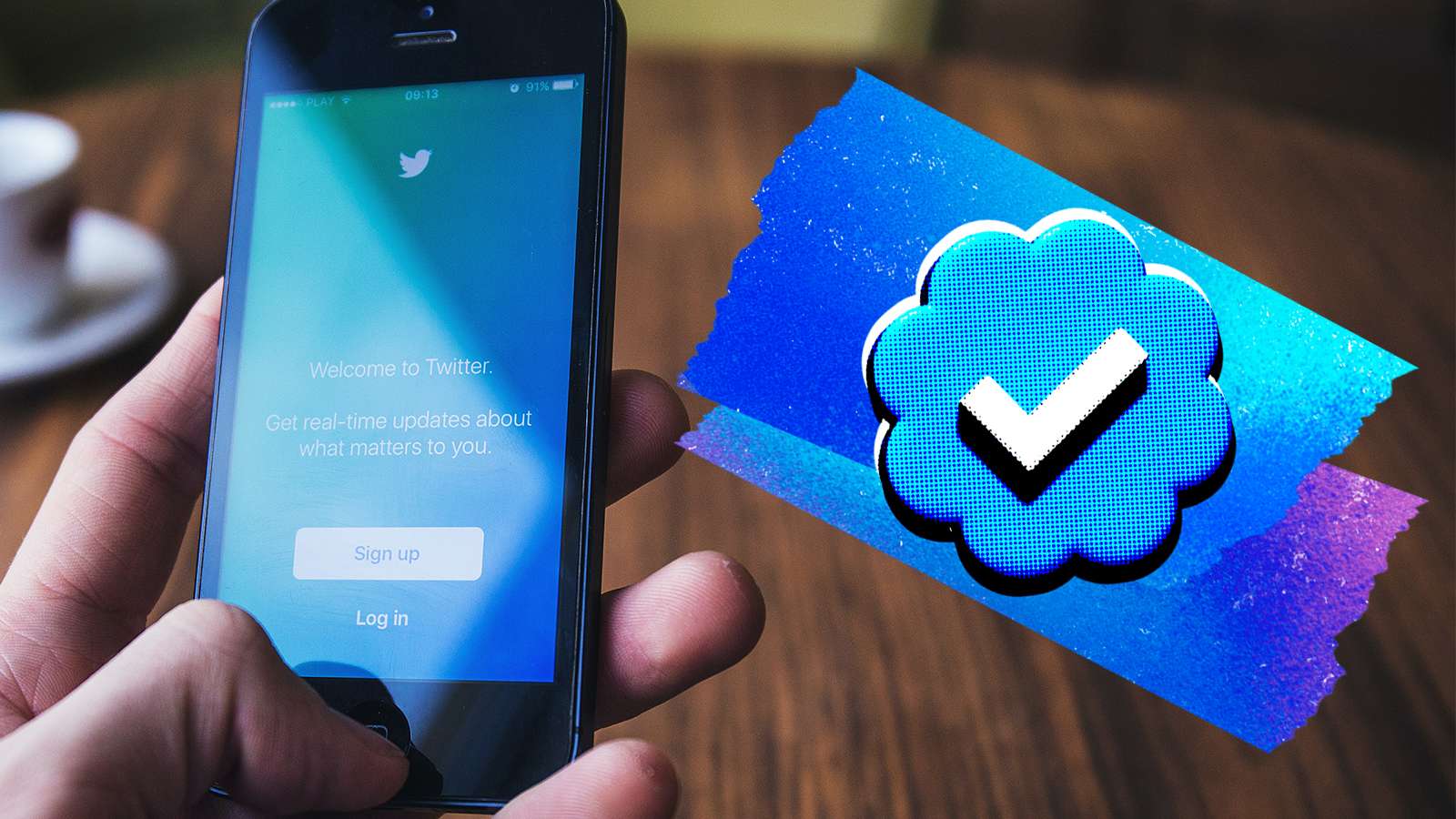 Twitter verification mark next to phone with app