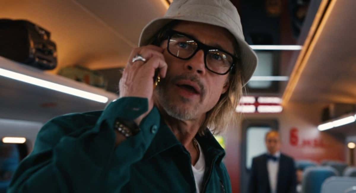 Brad Pitt as Ladybug talks on the phone in Bullet Train