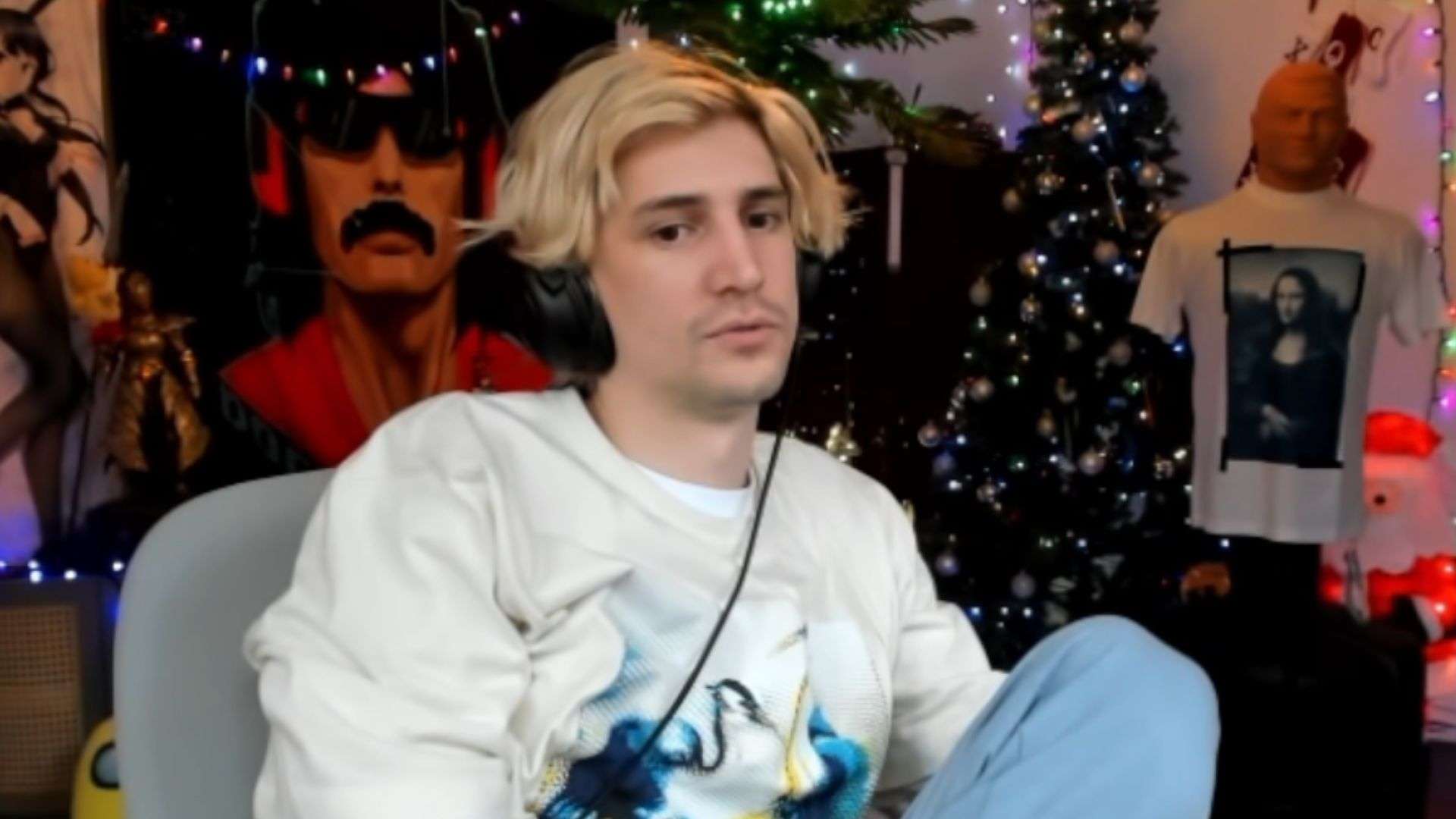 xQc looking at camera in white shirt and blue pants