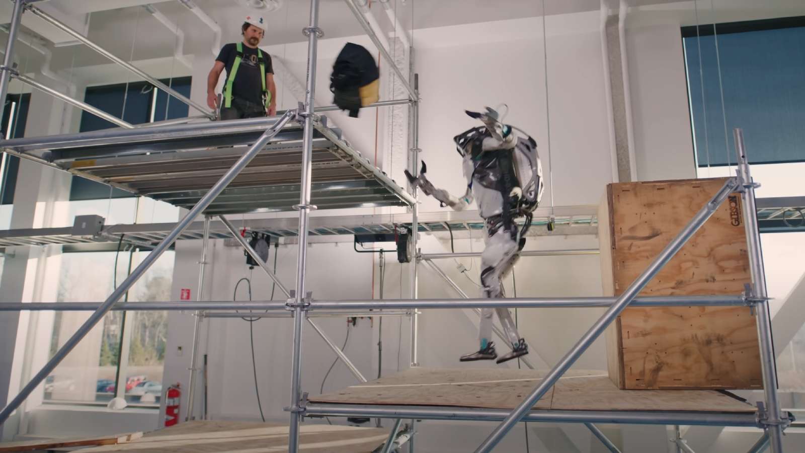 Boston Dynamics Atlas robot thwoing toolbox while jumping
