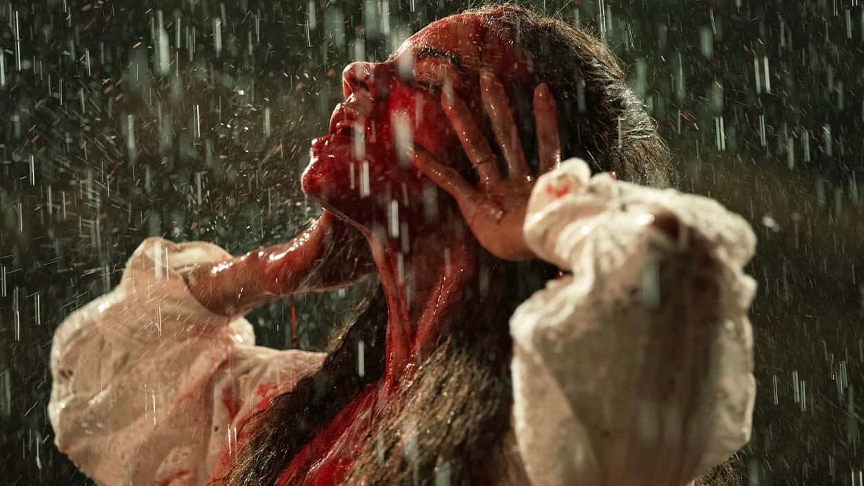 Hannah John-Kamen bathed in blood at the end of Unwelcome.