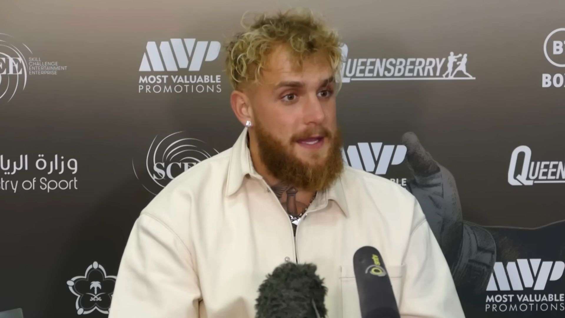 jake Paul in white shirt holding press conference
