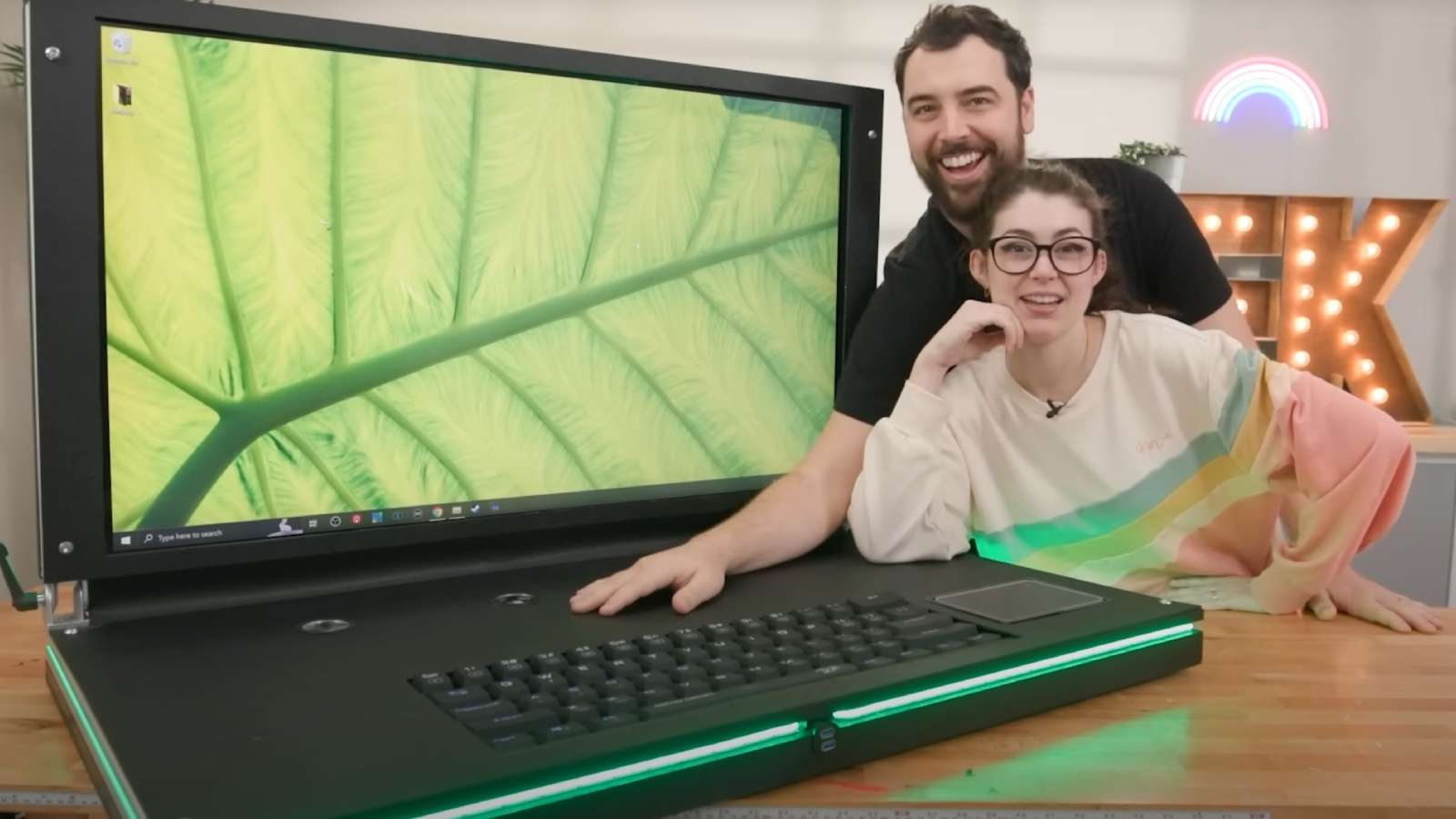 YouTubers posing with their DIY world's biggest laptop