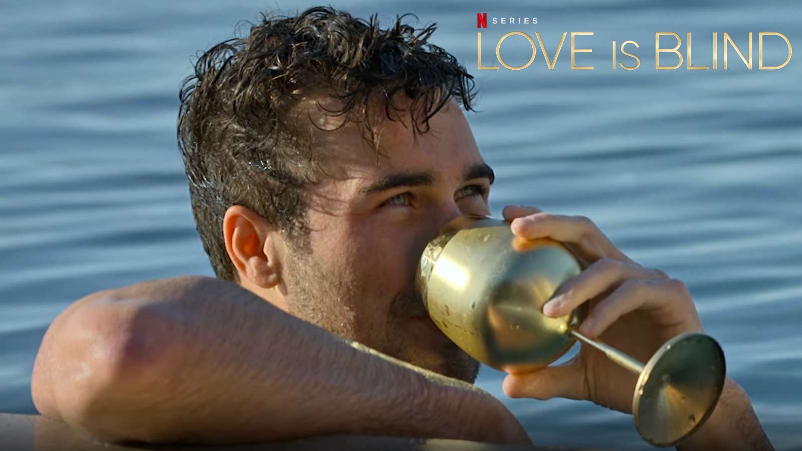 Love is Blind contestant holding a gold glass