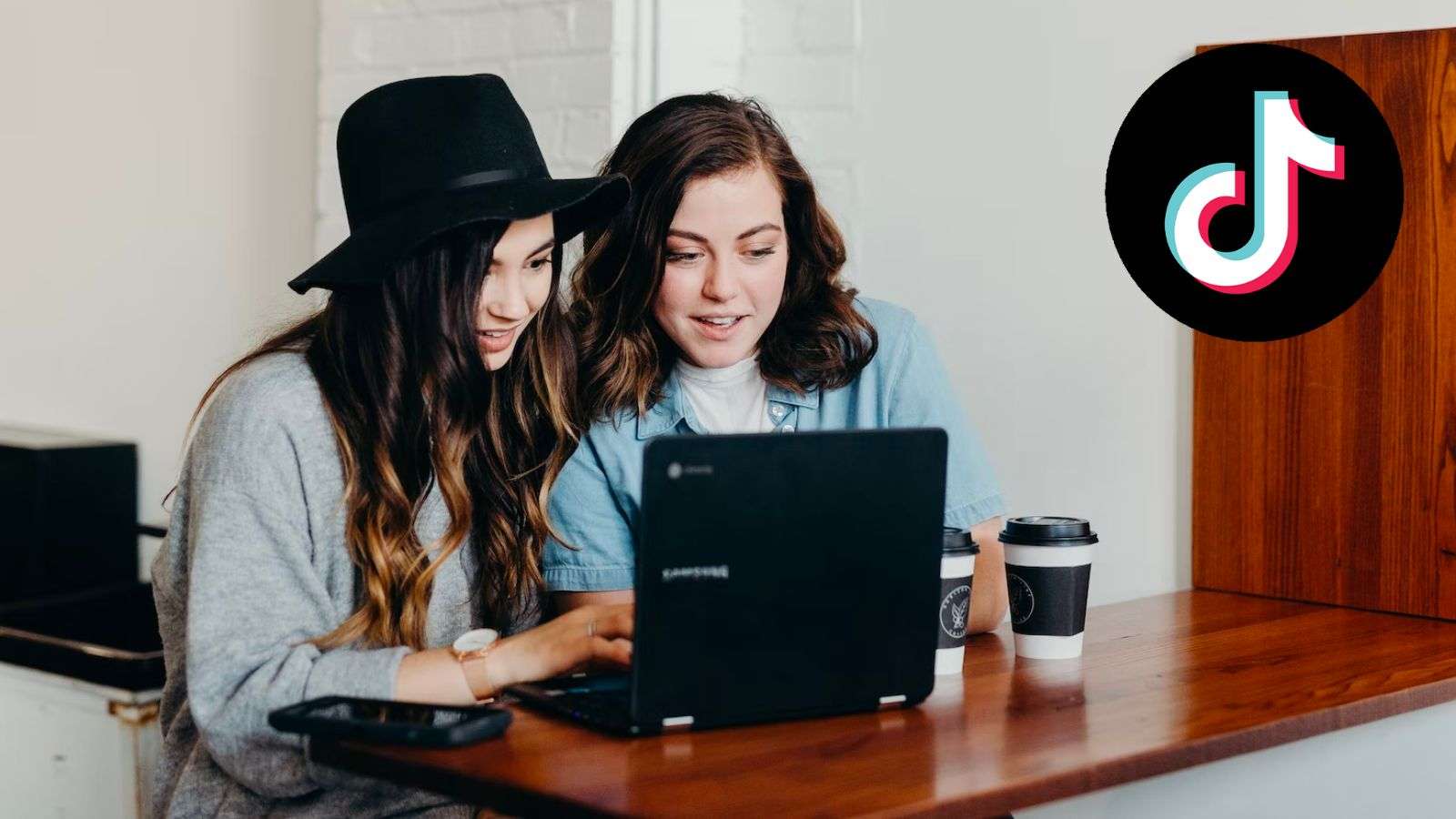 Two friends using a laptop