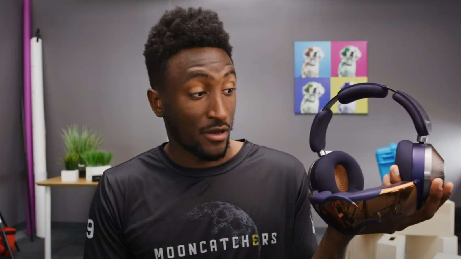 Marques Brownlee holding Dyson Zone headphones in studio