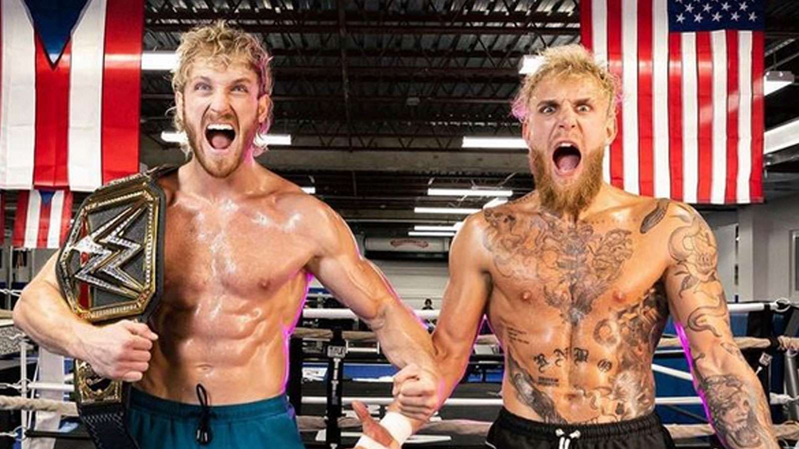 Logan Paul and Jake Paul with their shirts off stood in the boxing ring