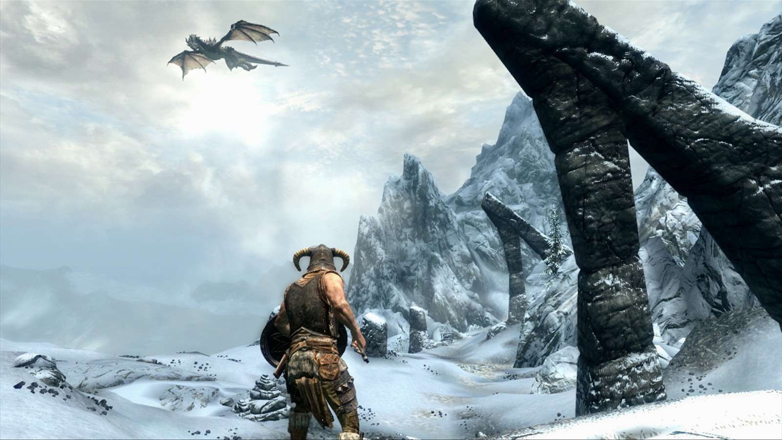 A screenshot of the playable protagonist in Skyrim with a dragon overhead.