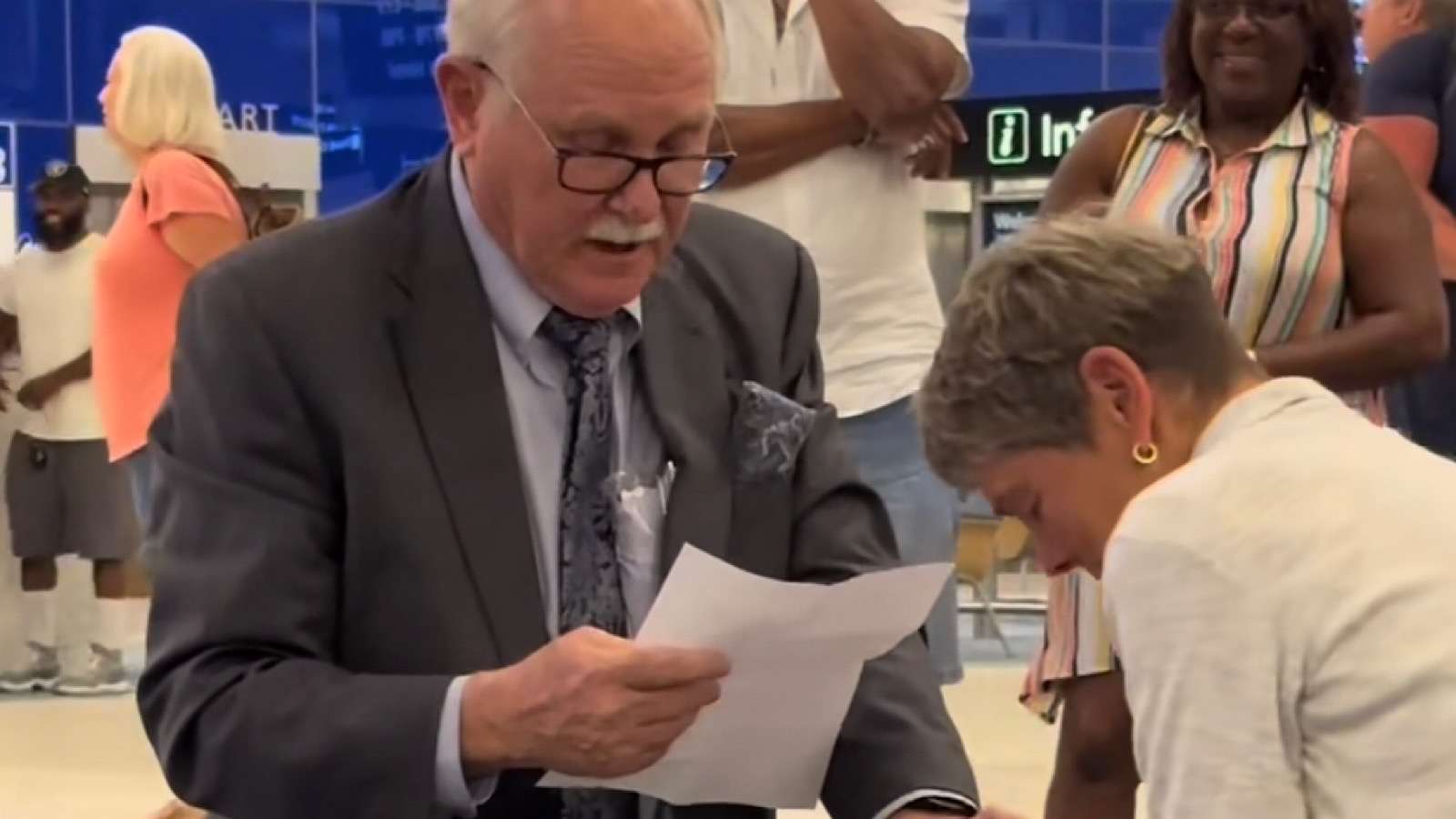 Elderly doctor proposes to his high school sweetheart in the middle of an airport.
