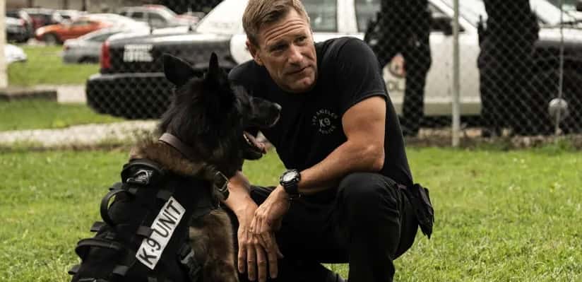 Aaron Eckhart and dog in Muzzle.