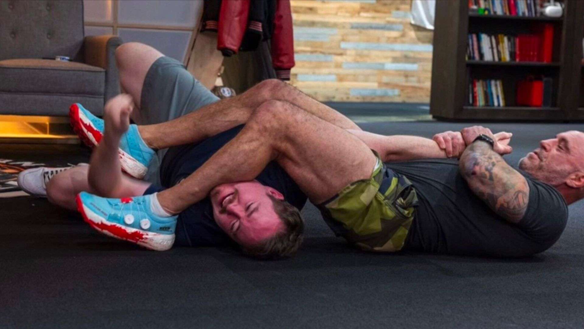 Joe Rogan and Shane Gillis wrestling on floor