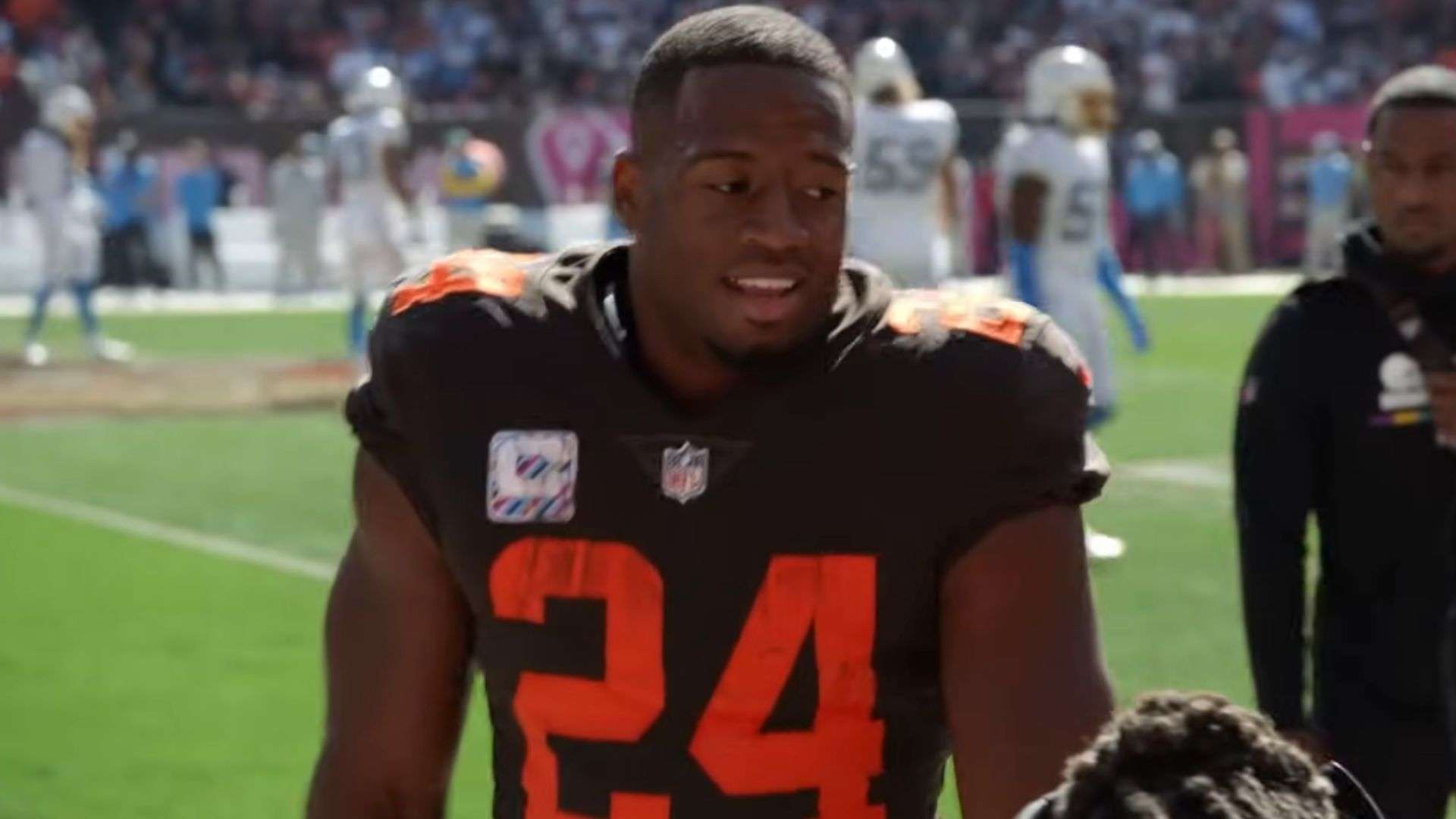 Nick Chubb with helmet off on sidelines in Cleveland Browns uniform