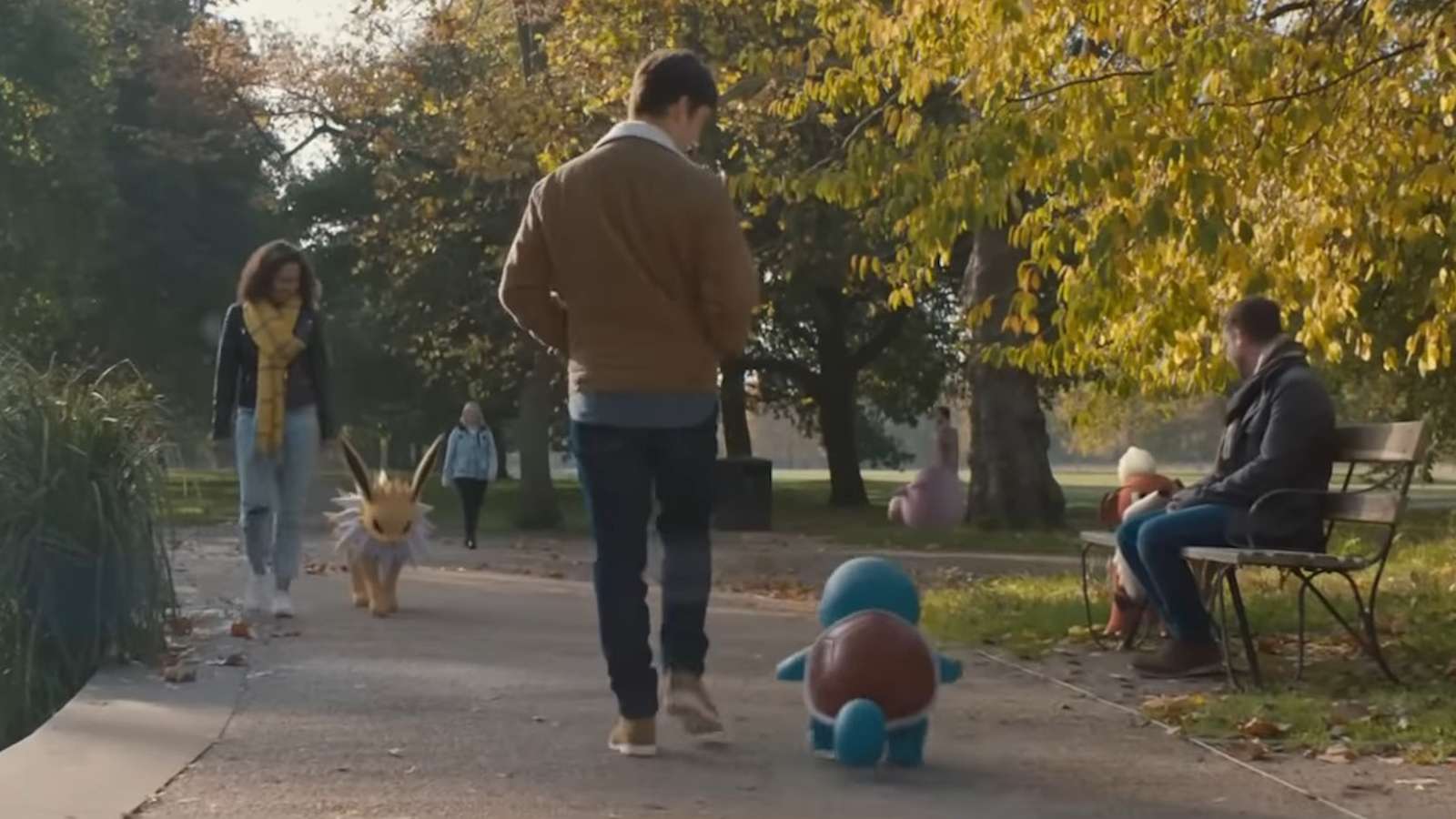 Pokemon Go walking with buddy pokemon in park.