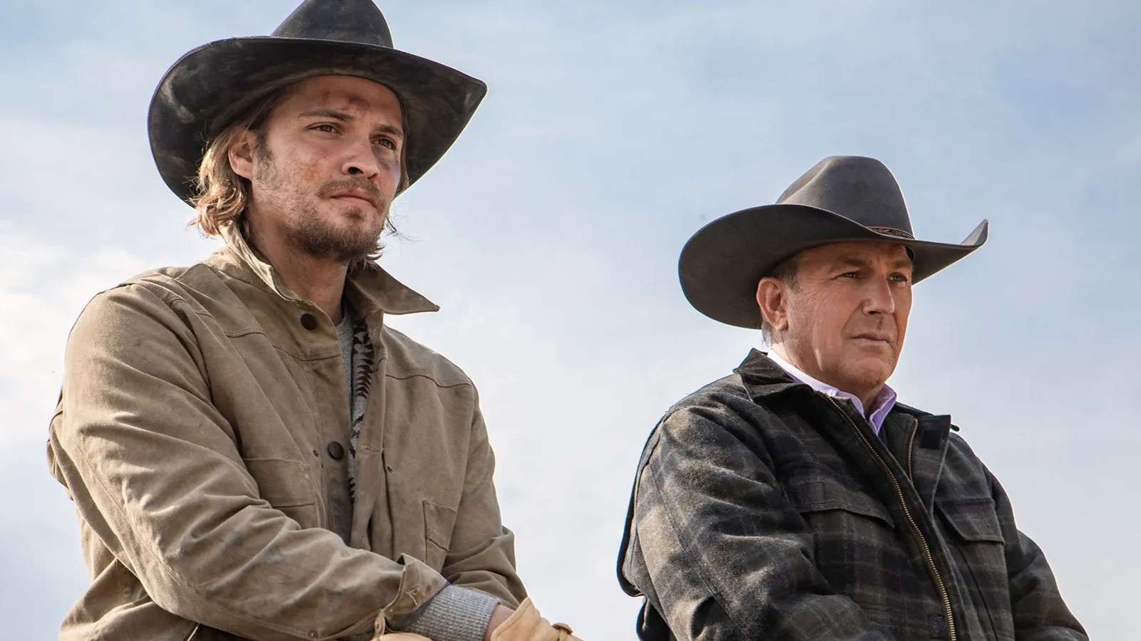 Luke Grimes and Kevin Costner on horseback in Yellowstone.