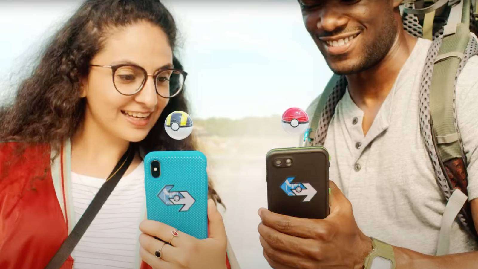 A live action trailer shows two Pokemon Go players preparing to trade, with virtual Poke Balls appearing above their phones