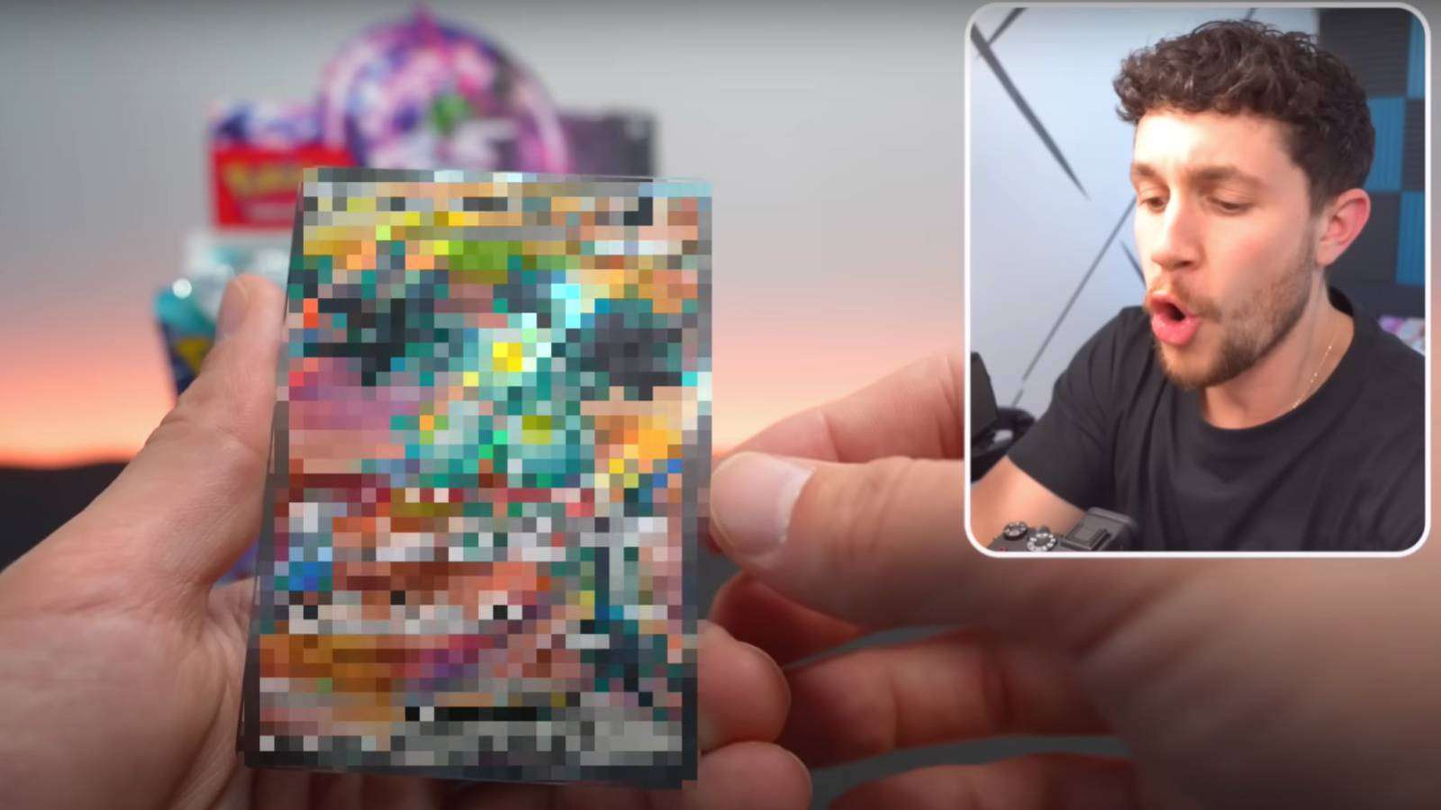 A screenshot from a YouTube video shows a white male creator opening pokemon card packs, with their reaction and face in the top right, and a blurred image of a pokemon card in the foreground