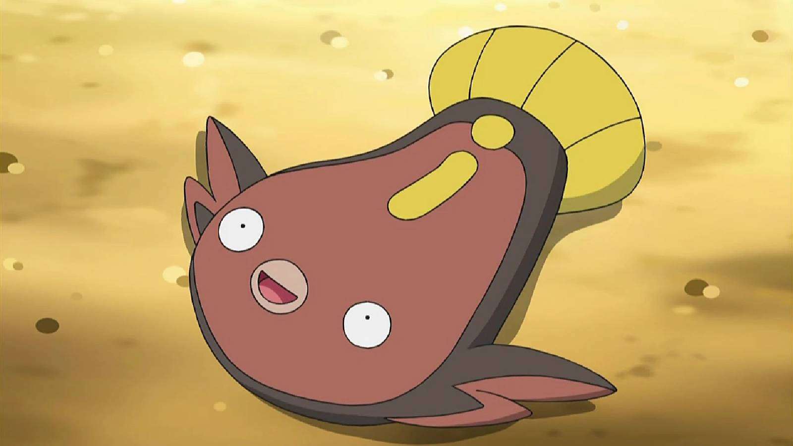 The Pokemon Stunfisk looks happily upwards while it lays flat on the ground