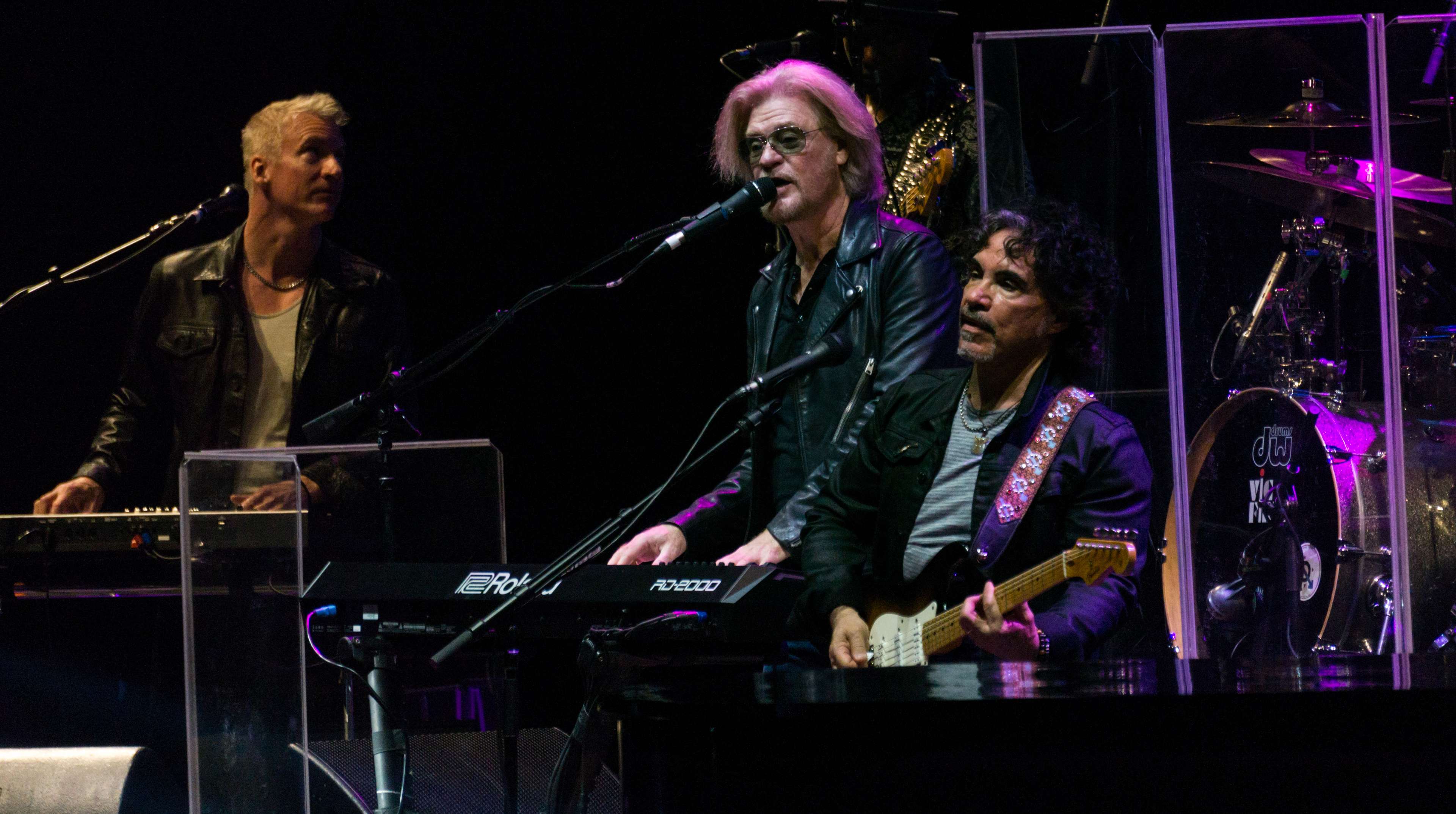 Daryl Hall and John Oates performing onstage in a concert
