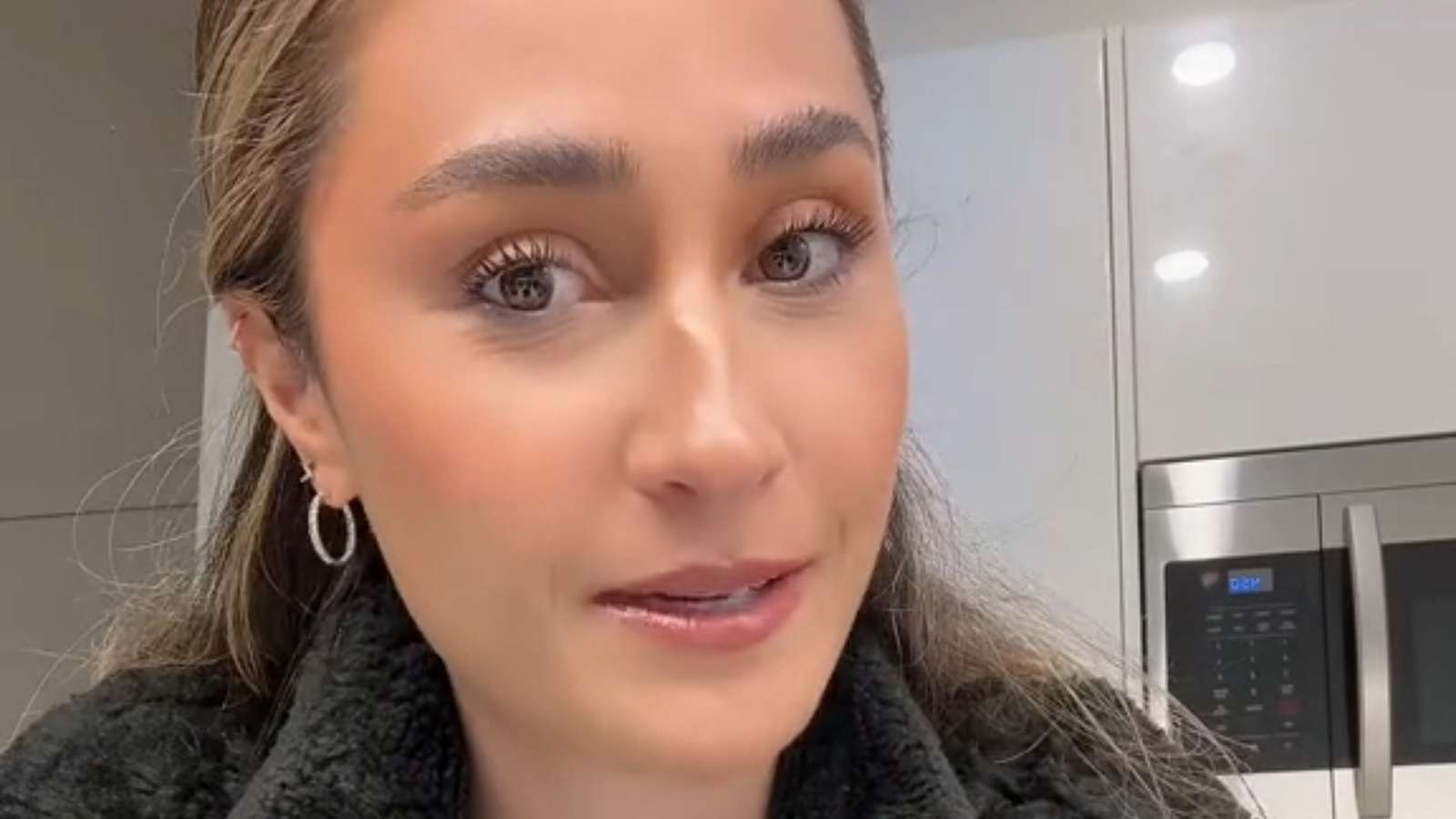 Woman looking into the camera filming a TikTok video