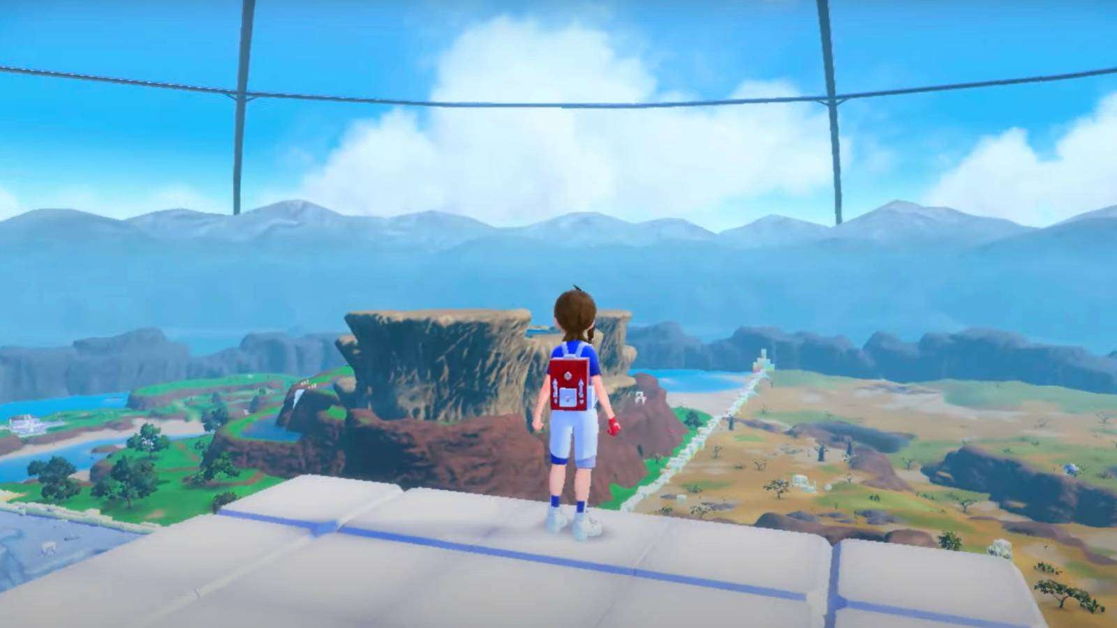 A Pokemon trainer looks out over The Terrarium in Pokemon Scarlet and Violet: The Indigo Disk