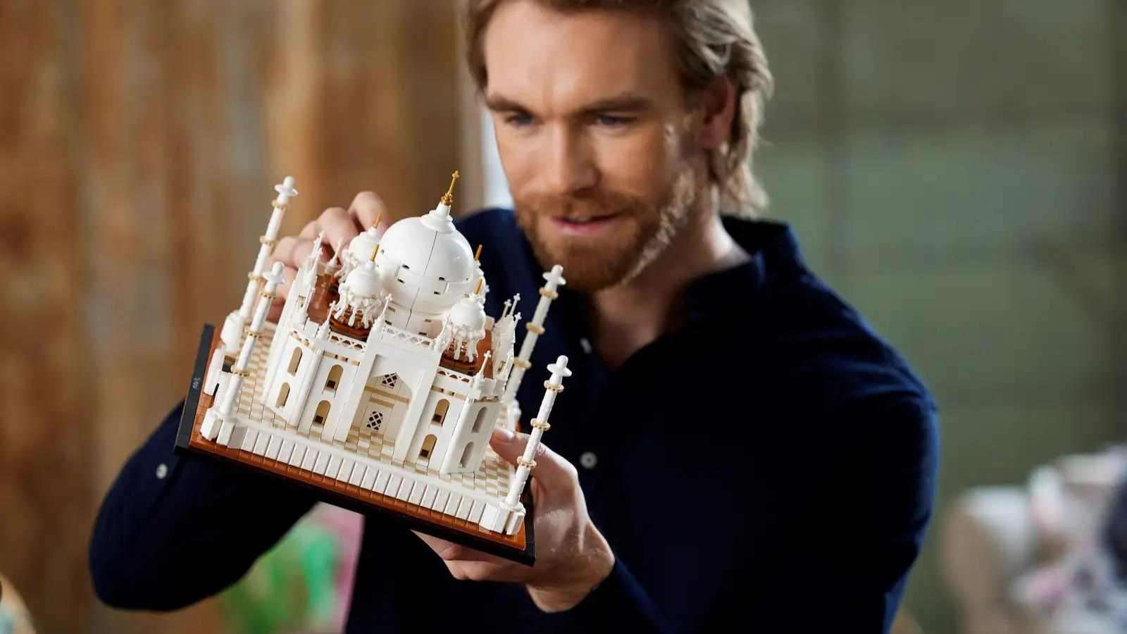 Adult admiring their LEGO Architecture Taj Mahal set.