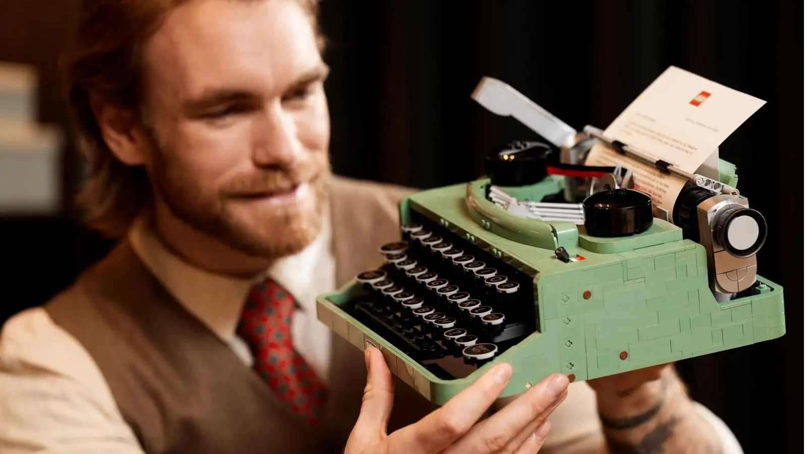 An adult admiring their LEGO Ideas Typewriter